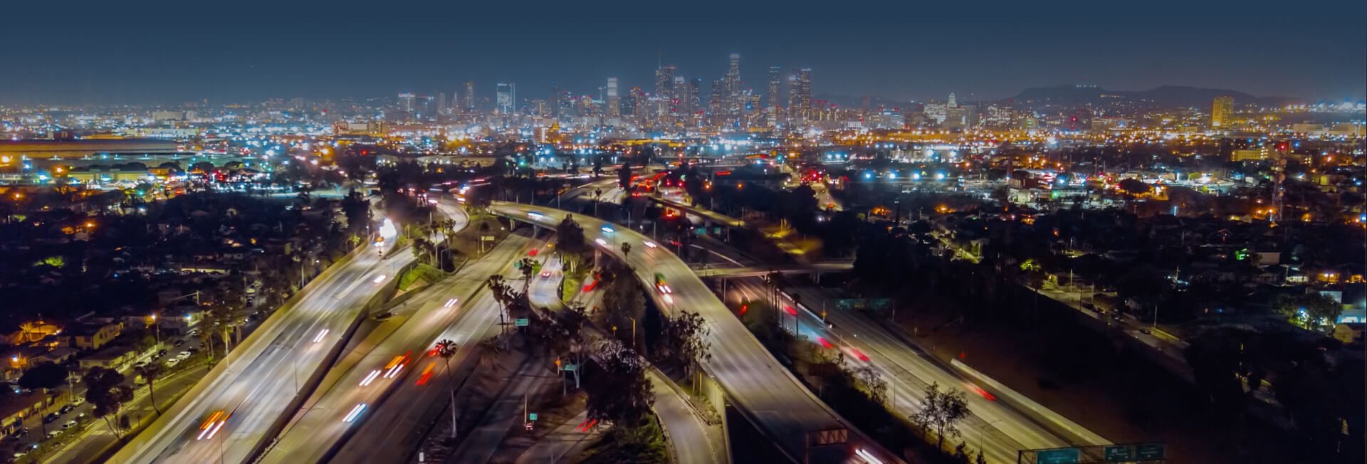 Michael Saeedian sits at a desk in front of framed accomplishments