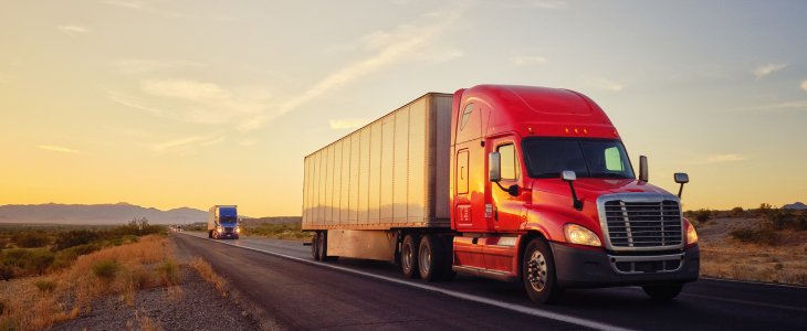 A truck driving down a dessert road