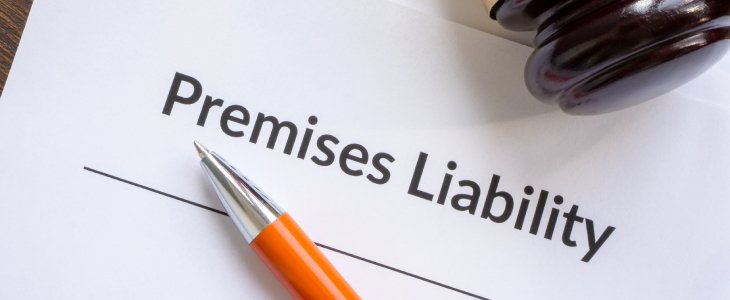 A pen with a piece of paper saying premises liability